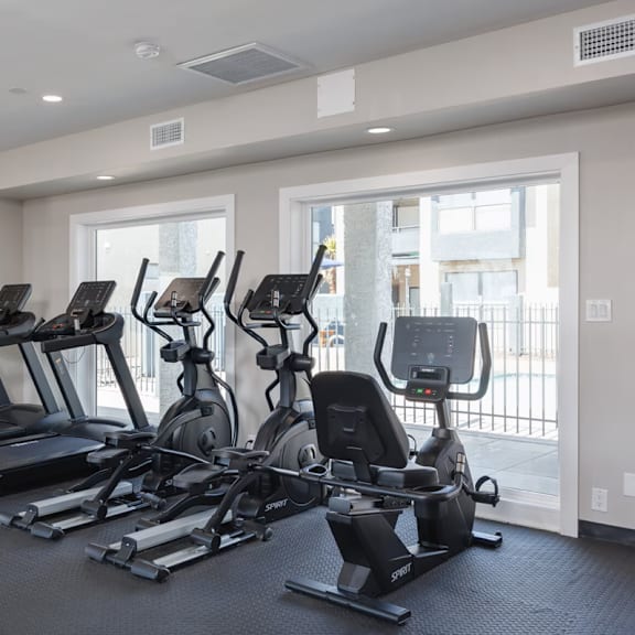 A spacious gym with treadmills, elliptical machines, and other exercise equipment.